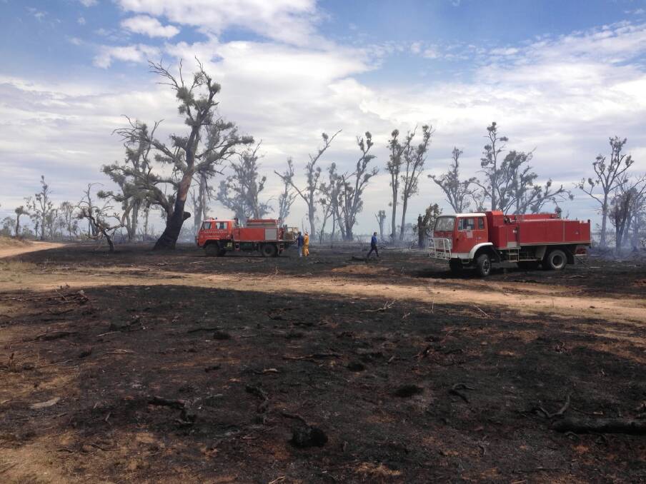 Firefighters mop up after fire broke out in Kyffins Reserve at Mulwala. Picture: GREY’DN DAVIS