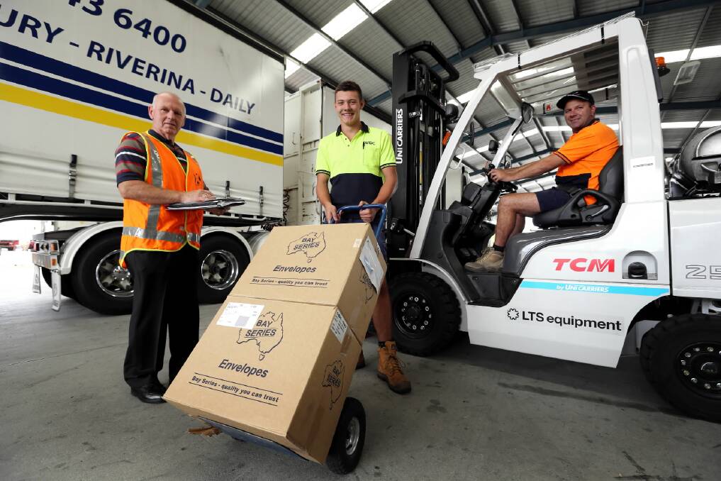 WorkCover Albury district co-ordinator Neville Burt, Albury Freight Distribution Centre trainee James Vogel and operations manager Tony Burns are encouraging workers to be aware of the dangers that come with manual handling. Picture: MATTHEW SMITHWICK