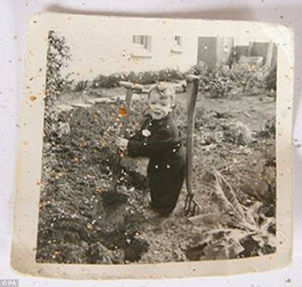 Mystery: A faded photo of a toddler that dates back to 1952 was found in a wallet lying near the body. Photo: Devon and Cornwall police