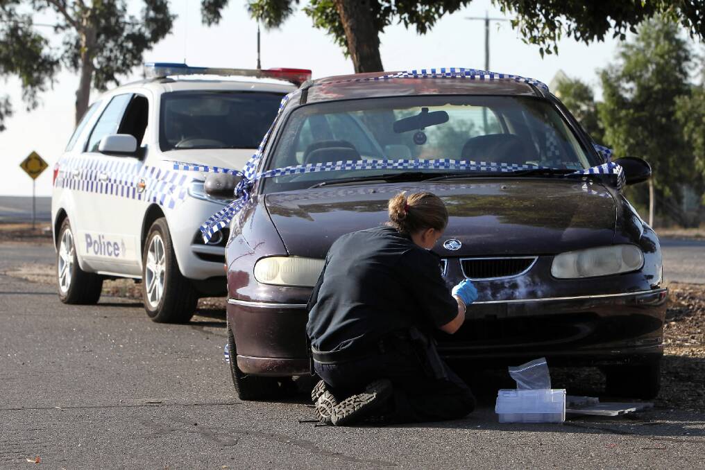Police dust a car stolen car for fingerprints in Wodonga yesterday morning. Picture: KYLIE ESLER