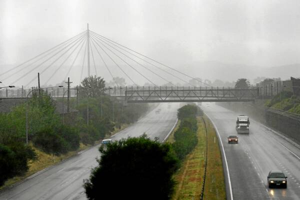 Grey skies and showers envelop Harold Mair Bridge yesterday, even though Albury Airport’s rain gauge did not record any activity this month. Picture: BEN EYLES