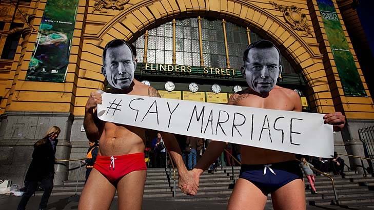 Pro-gay marriage advocates draw attention to Tony Abbott's anti- same sex marriage stance. Photo: Jason South