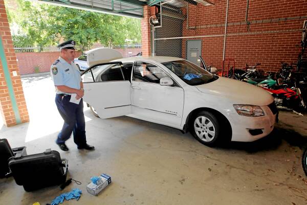 Insp Chris Wallace looks over the car that was allegedly carrying the 15 kilograms of cannabis. Picture: DAVID THORPE