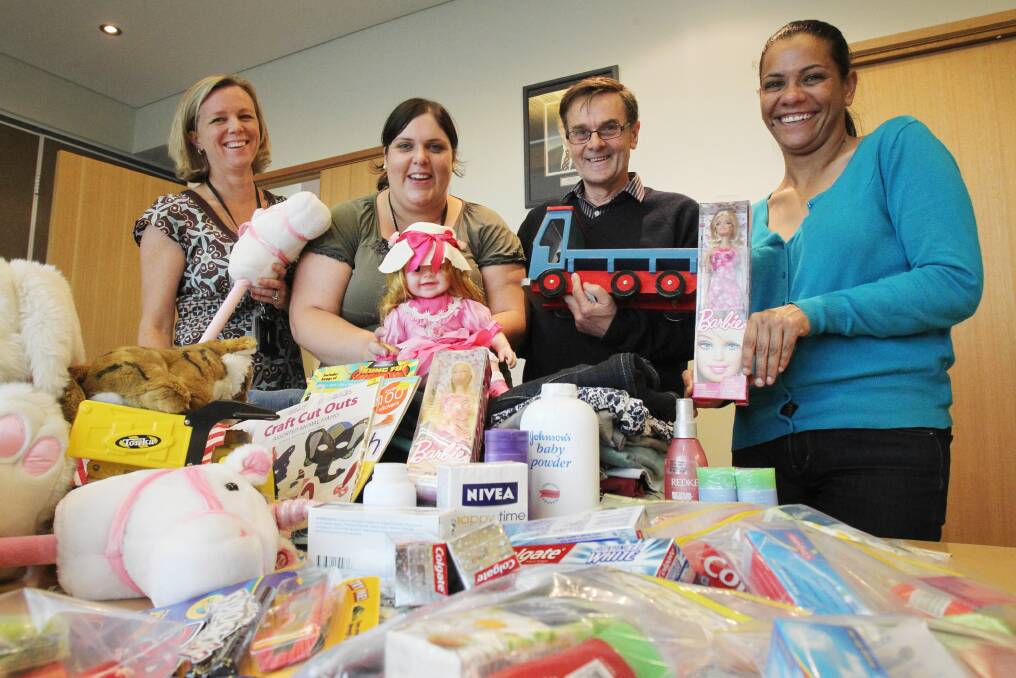 Hume Building Society’s general manager Melissa Sweetland and its community and events co-ordinator Anna Gill join Albury-Wodonga Community Network chairman Colin Alcock and chief executive Angelina Moore-Tabuteau with goods donated to Betty’s Place. Picture: MARK JESSER