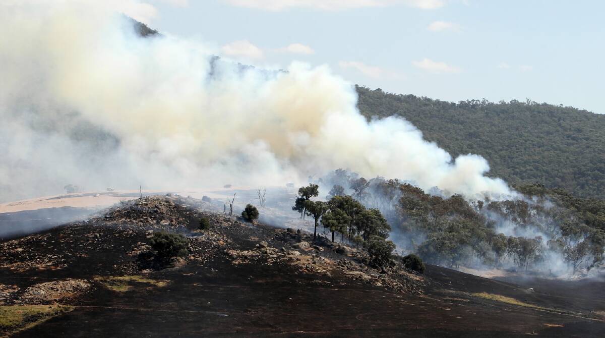 There was plenty of smoke but no houses came under threat from this 10-hectare grass fire Granya. Pictures: MARK JESSER