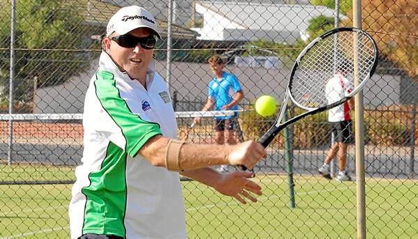Darren O’Connor, of Wodonga Huon, plays a shot as part of Country Week action at Wodonga Tennis Centre yesterday.