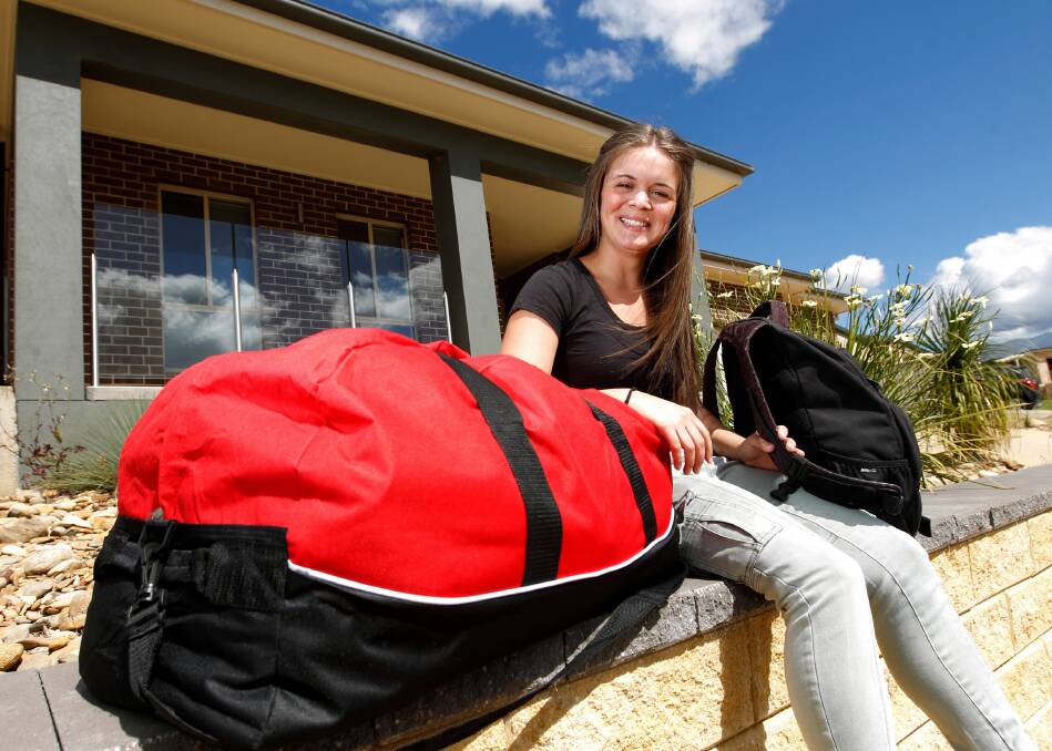 Stevie Smith, 19, of Leneva, with the large bag of clothes she will take to the Philippines today. Picture: BEN EYLES