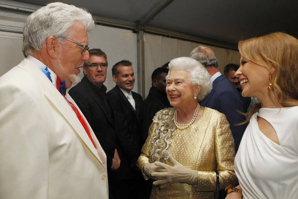 Queen Elizabeth II talks with Rolf Harris (L) and Kylie Minogue (R) backstage after the Diamond Jubilee Buckingham Palace Concert in London, England in 2012. Photo: WPA