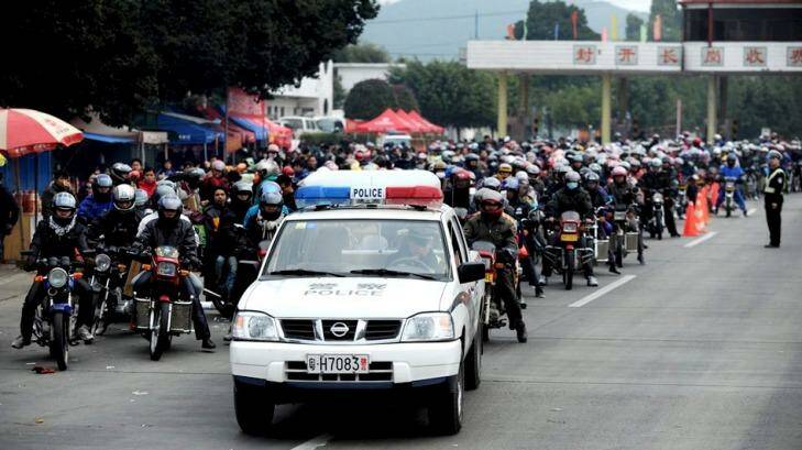 The huge amount of people travelling home by motorcycle has prompted police escorts. Photo: ChinaFotoPress