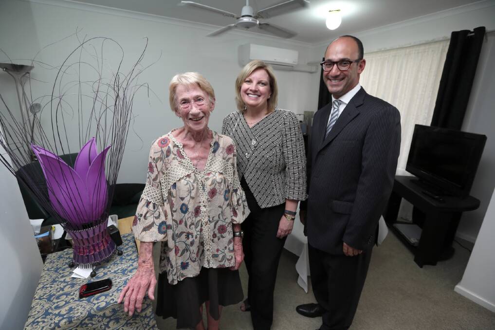 Jean Jones gives Victorian Housing Minister Wendy Lovell and Harlea Properties director Daniel Teller a tour of her new home yesterday. Picture: Matthew Smithwick