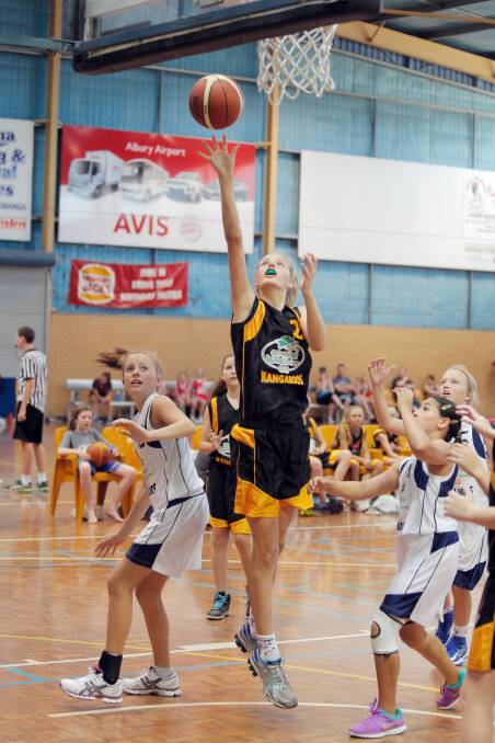 Neve Tratt, of Dubbo, makes her way to the rack for a lay-up.