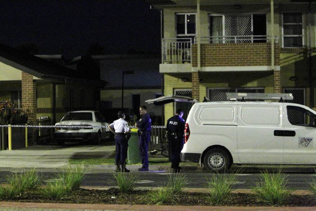 Police confer outside the Mate Street block of flats in North Albury. Picture: MARK JESSER