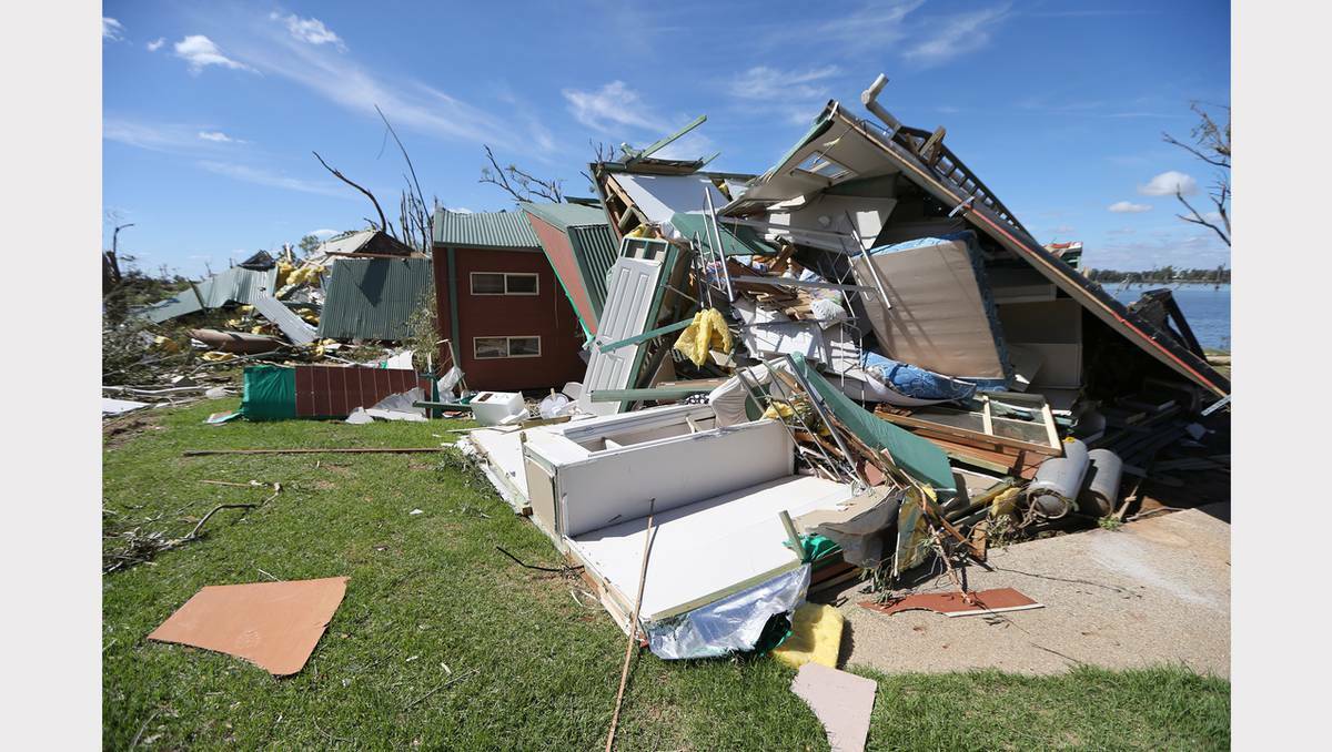 Sifting through the wreckage at Denison County Caravan Park. Photo: JOHN RUSSELL