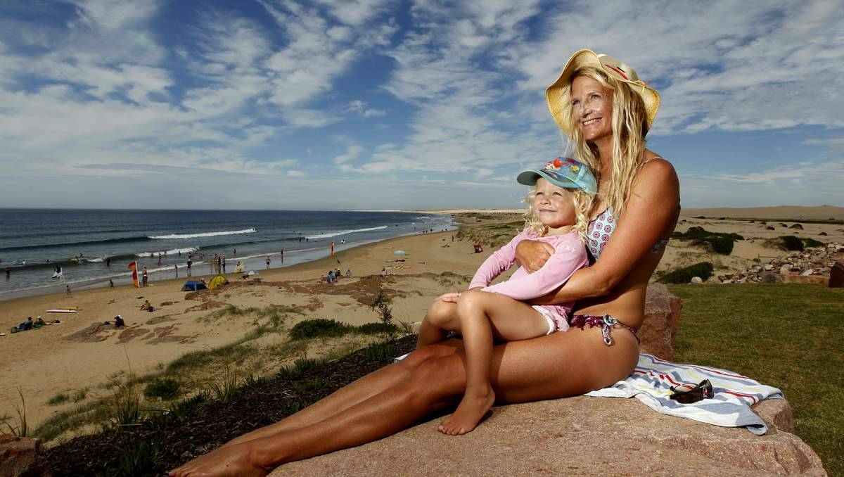 Suellen Goyne, from Corlette, with daughter Nirvana Goyne, 2, on holidays at Birubi Beach. Picture: Jonathan Carroll