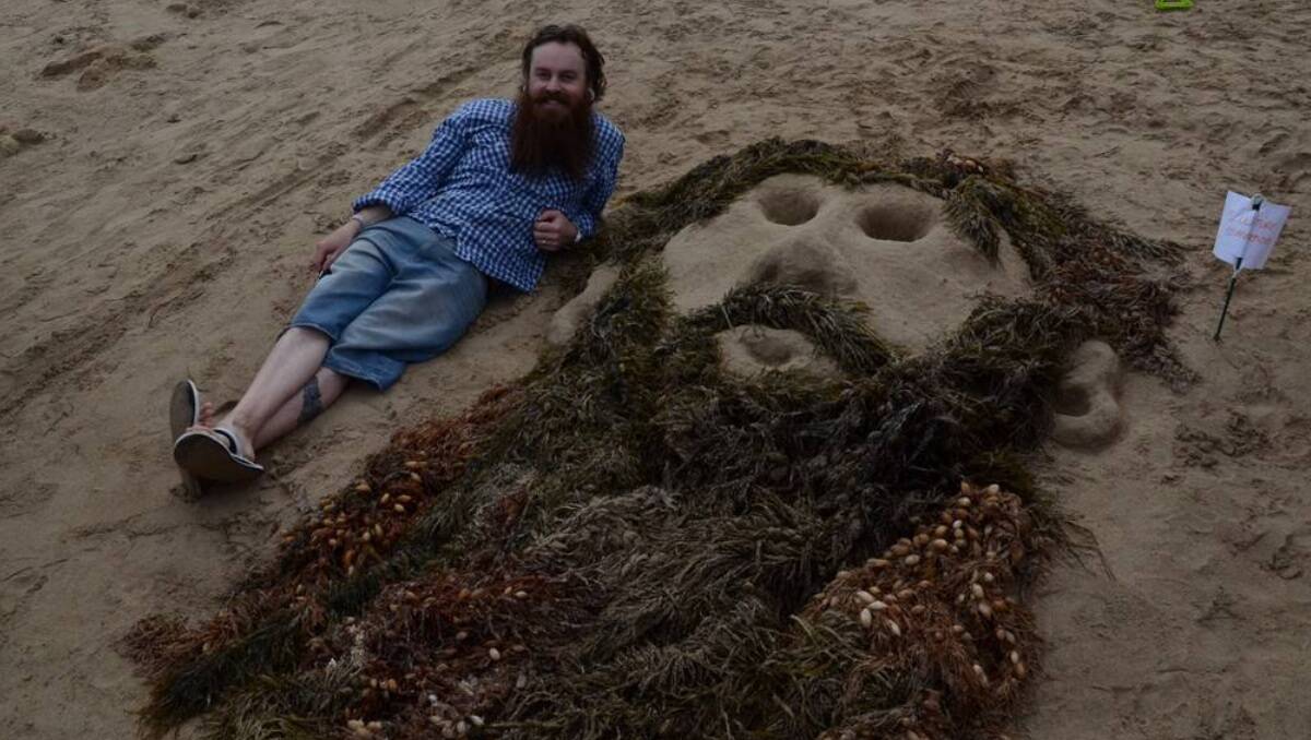 Ewan Stewart pictured with ‘Portrait’ – created by wife Jacinda, daughter Madeline, Kelly Hedditch and Eleanor Stewart at the Broulee Sand Modelling and Sand Castle Competition.