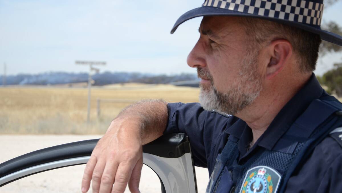 Senior Constable Martin Biro mans the roadblock at the intersection of Plantation Road and Bremmer Valley Road.