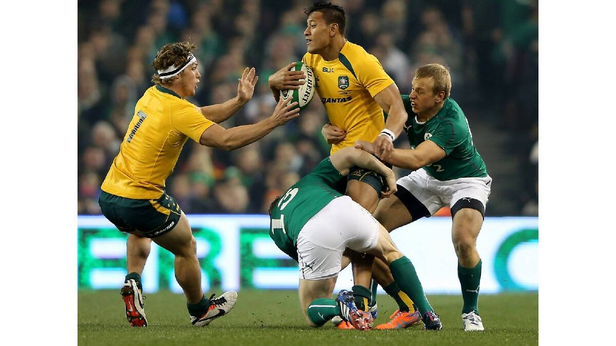 Luke Marshall and Brian O'driscoll of Ireland tries to tackle Israel Folau of Australia during the International match between Ireland and Australia. Photo: Getty Images.
