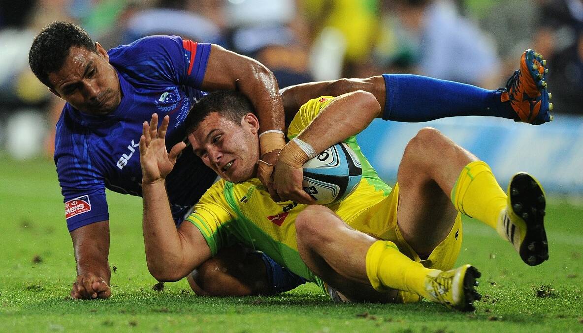 Alex Gibbon of Australia is tackled by Reupena Levasa of Samoa during the Gold Coast Sevens round one match between Samoa and Australia. Photo: Getty Images.
