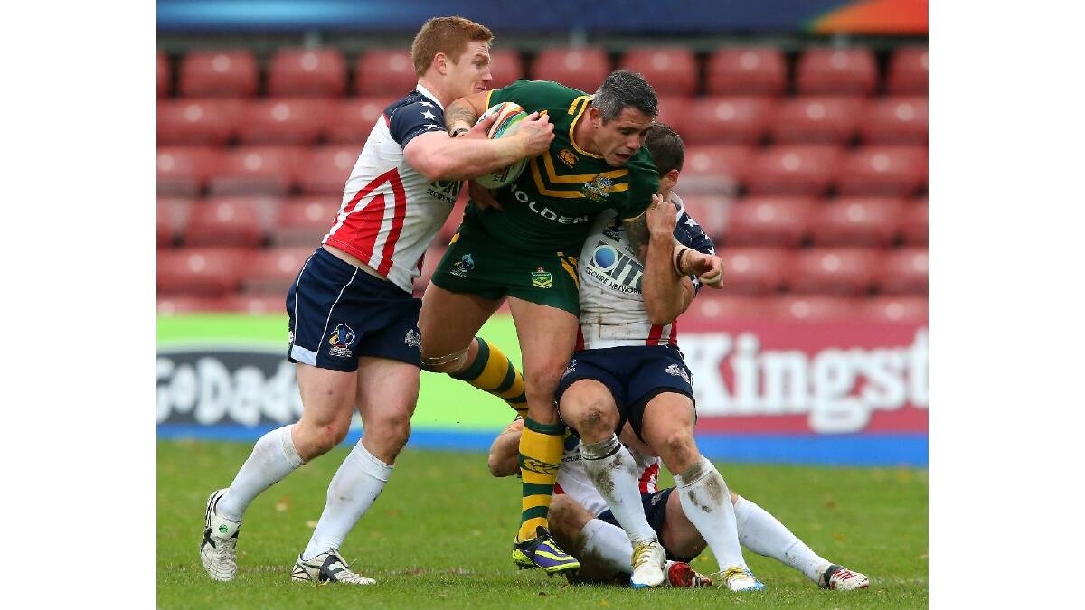 Corey Parker of Australia is tackled by Mark Offerdahl of USA during the Rugby League World Cup Quarter Final match between Australia and the USA. Photo: Getty Images.