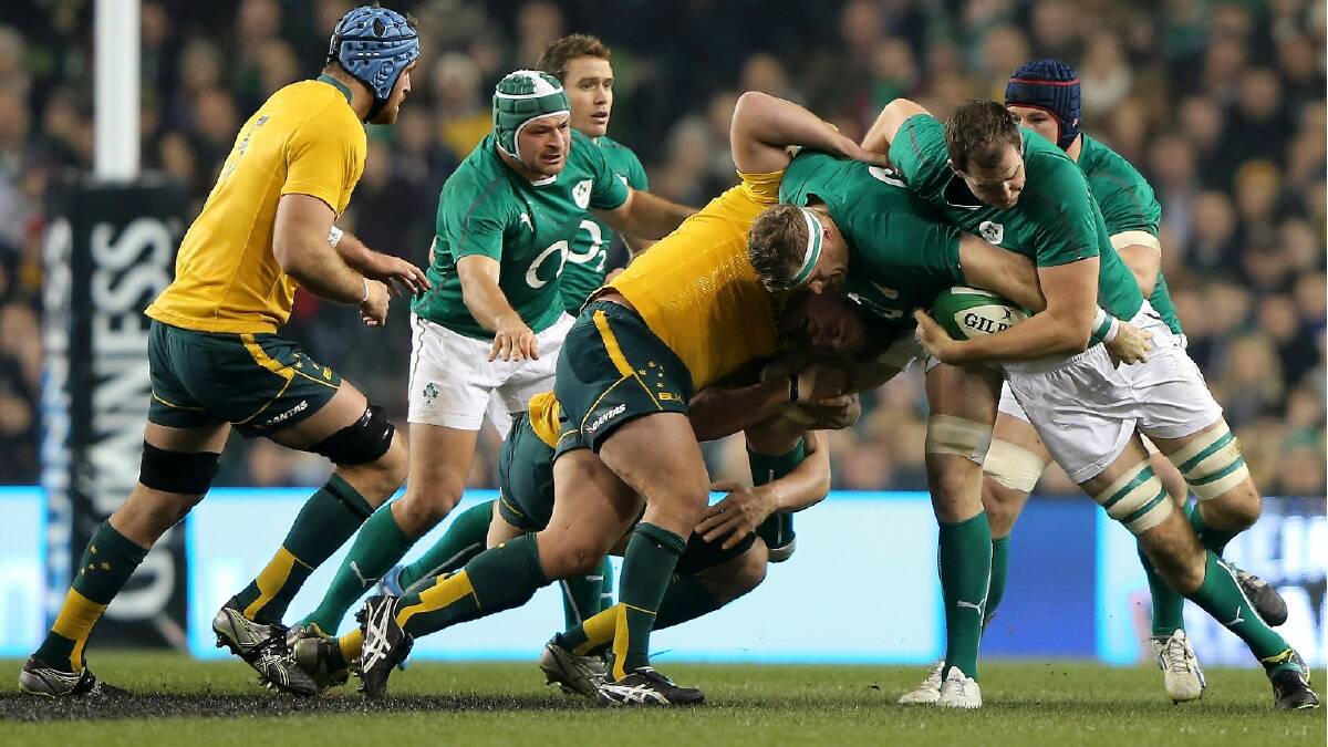 Stephen Moore of Australia tries to tackle Jamie Heaslip of Ireland during the International match between Ireland and Australia. Photo: Getty Images.