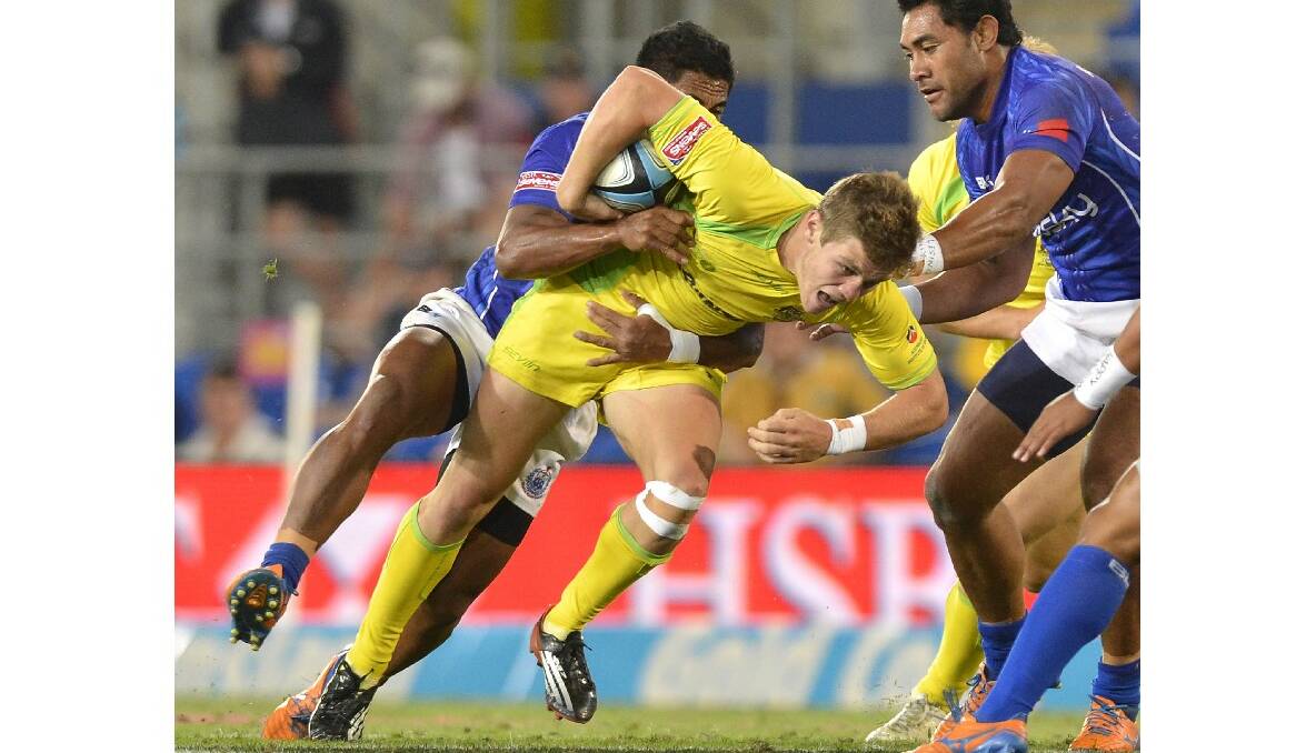 Tom Lucas of Australia attempts to break through the defence during the Gold Coast Sevens round one match between Australia and Samoa. Photo: Getty Images.
