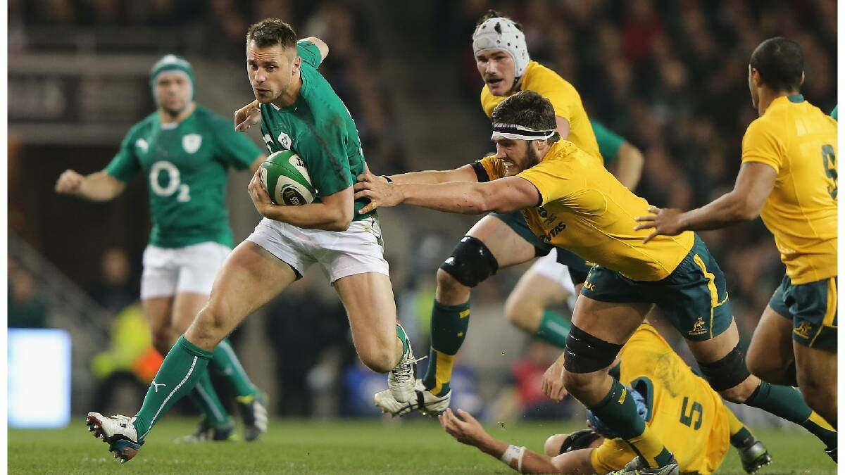 Rob Simmons of Australia tries to tackle Tommy Bowe of Ireland during the International match between Ireland and Australia. Photo: Getty Images.