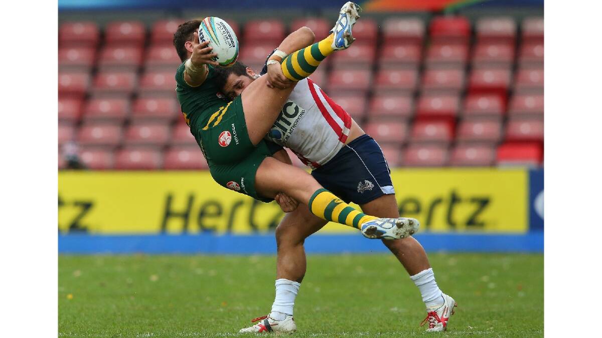 Josh Papalii of Australia is tackled by Bureta Faraimo of USA during the Rugby League World Cup Quarter Final match between Australia and the USA. Photo: Getty Images.