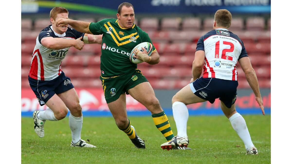 Matthew Scott of Australia runs at Matthew Shipway of USA during the Rugby League World Cup Quarter Final match between Australia and the USA. Photo: Getty Images.