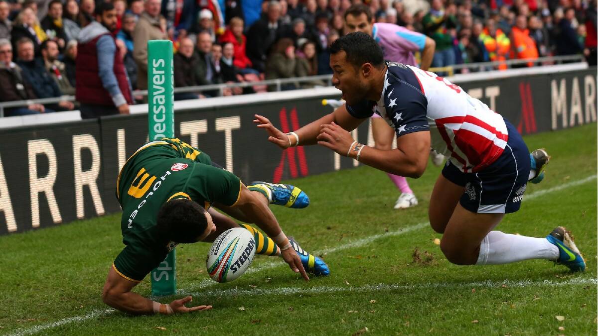 Jarryd Hayne of Australia dives over the line to score the opening try during the Rugby League World Cup Quarter Final match between Australia and the USA. Photo: Getty Images.
