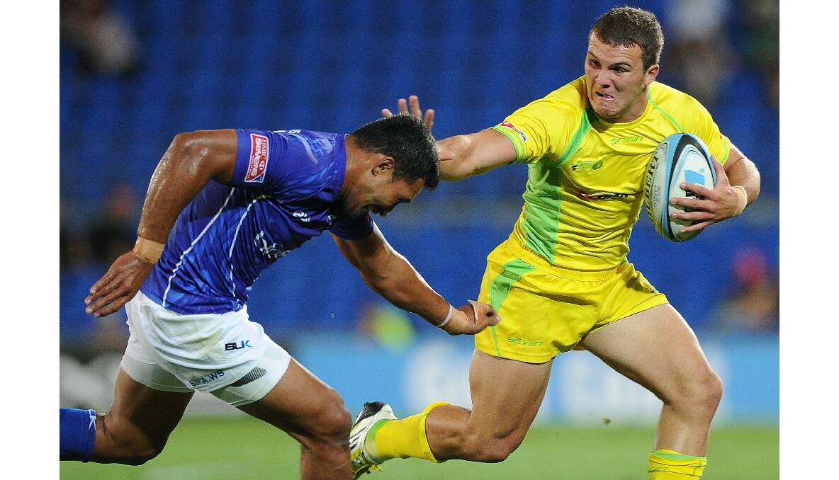 Alex Gibbon of Australia takes on the defence during the Gold Coast Sevens round one match between Samoa and Australia. Photo: Getty Images.