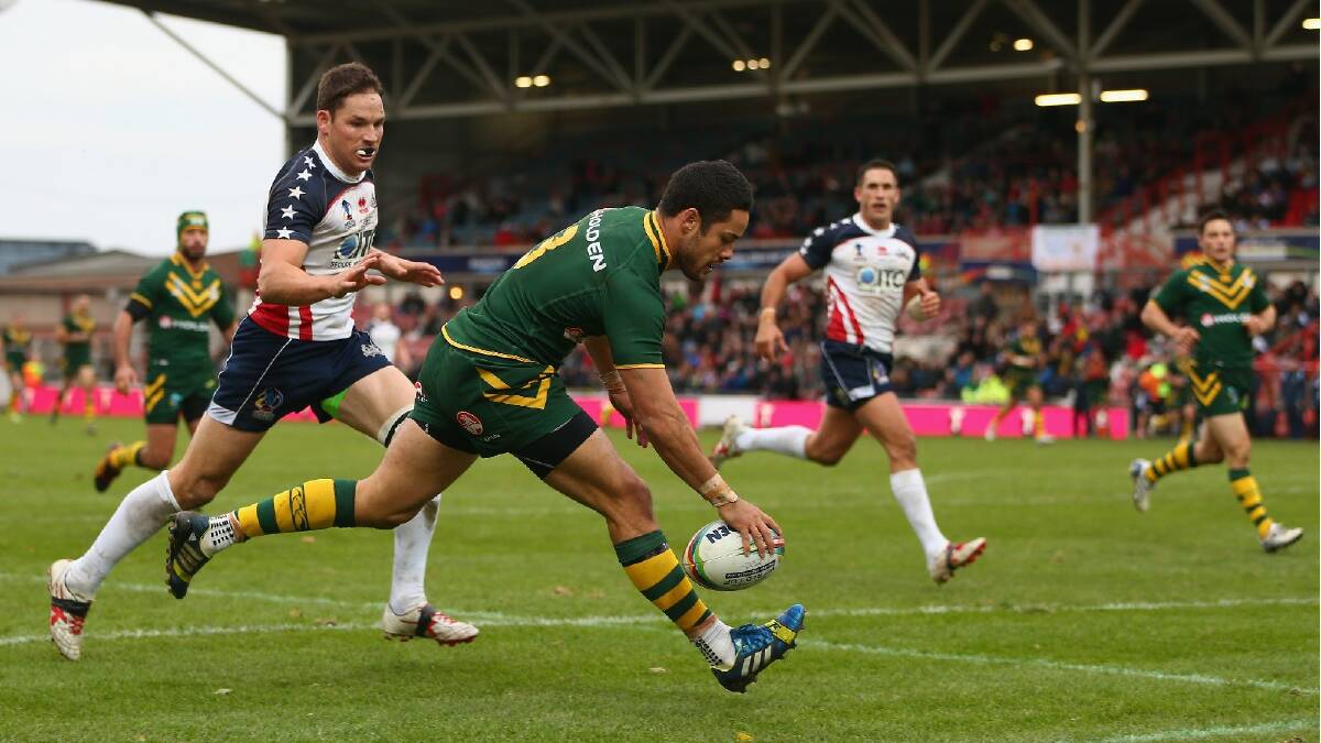 Jarryd Hayne of Australia scores a try as Daniel Howard (L) of USA looks on during the Rugby League World Cup Quarter Final match between Australia and the USA. Photo: Getty Images.