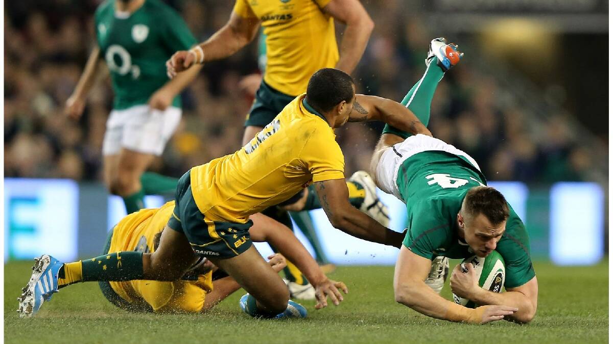 Will Genia of Australia tries to tackle Tommy Bowe of Ireland during the International match between Ireland and Australia. Photo: Getty Images.
