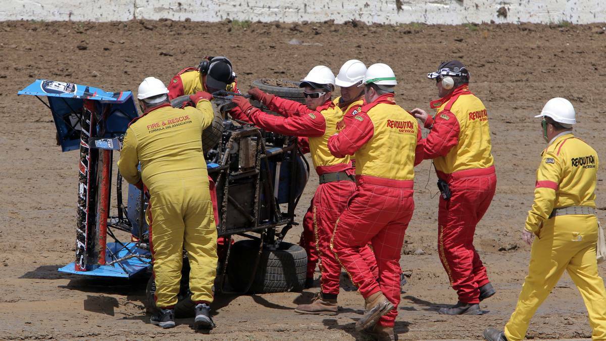 THE STANDARD: The Premier Speedway crash crew assist Ash Sinclair after his crash in the Formula 500. Picture: DAVE LANGLEY