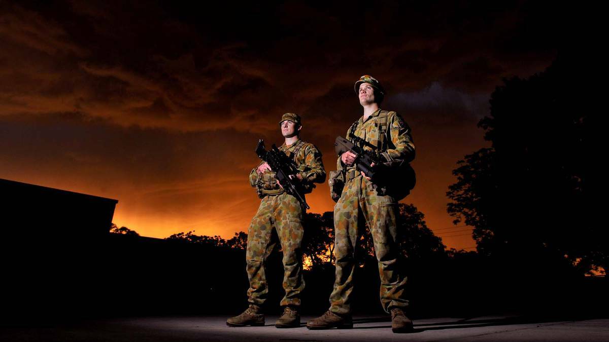 DAILY ADVERTISER: Private Tom Barron and Lance Corporal Pete Hubbard as the sun set at the Army Reserve open day. Picture: Addison Hamilton