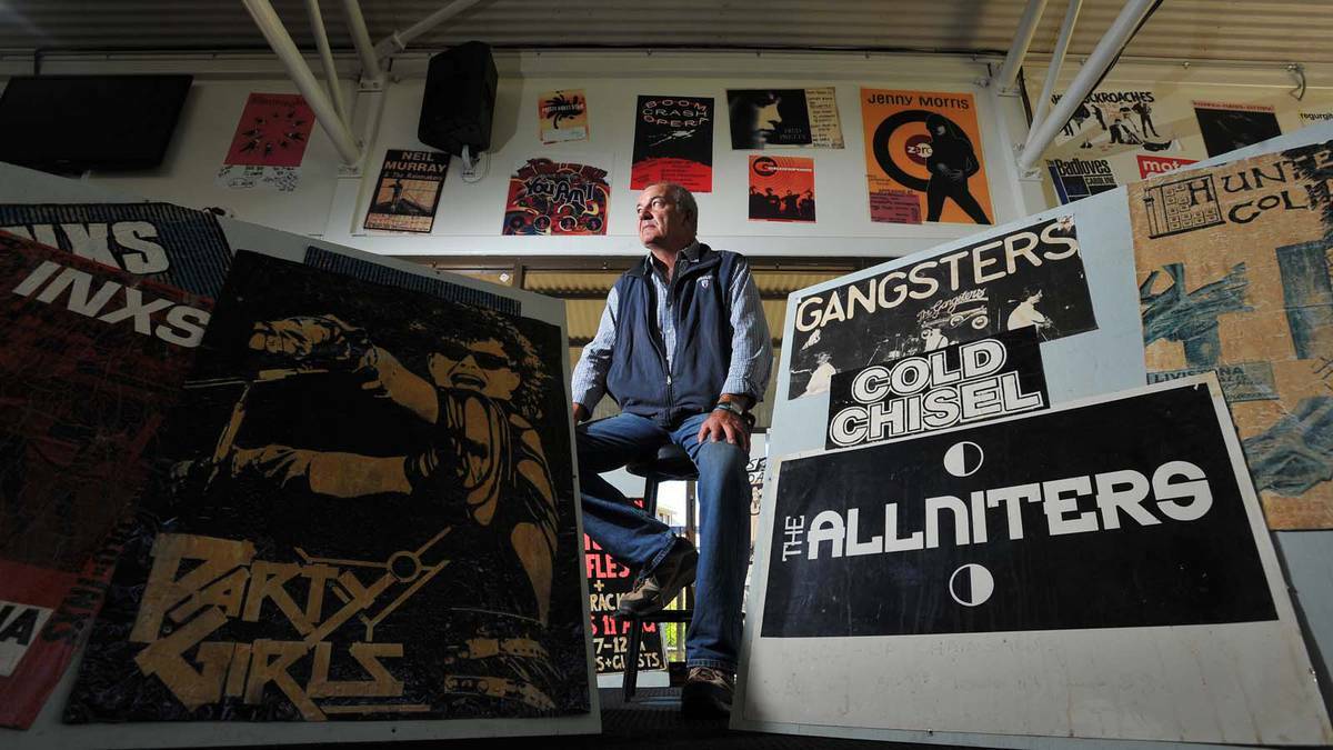 DAILY ADVERTISER: CSU's Roger Ansell with just some of the posters advertising the bands that have performed at the uni over the years. Picture: Addison Hamilton