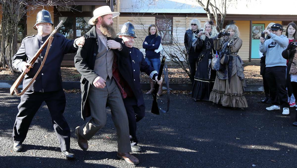 BEECHWORTH: Ned Kelly taken into a buggy to be transported to the jail. Policemen are played by Owen Clarke and Stuart Duff, Ned Kelly is played by John Murphy. Pictures: Peter Merkesteyn