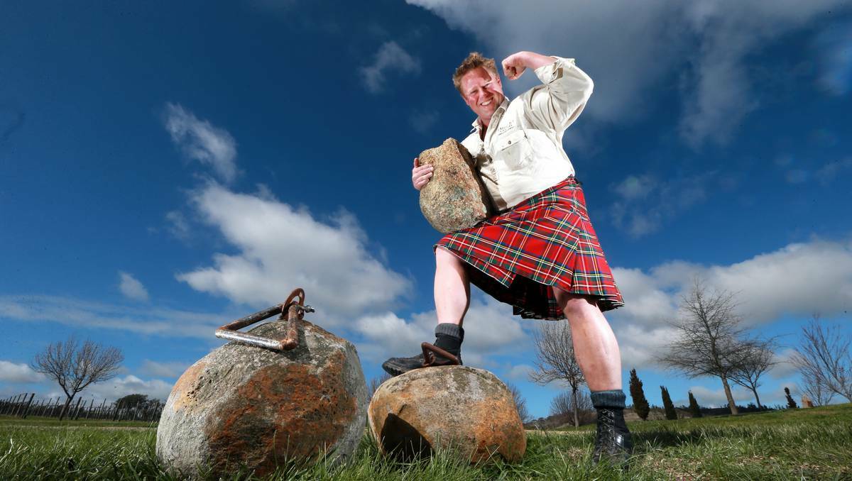 BEECHWORTH: Amulet Vineyard winemaker Ben Clifton tries out the 94-kilogram stone and a 116-kilogram stone used for the Binks Stone Carry event ahead of Beechworth’s annual Highland Games tomorrow. Picture: John Russell