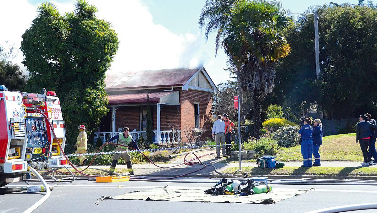 INVERELL: Smoke billows from the Inverell home where a woman died. Picture: Inverell Times