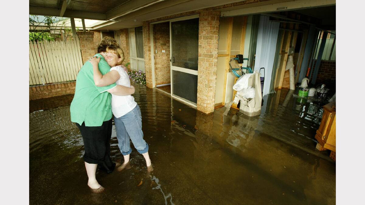 Wodonga was hit by a storm that caused flash flooding.  L-R Leisa Kelly is comforted by Lynn Campbell after rising waters entered Leisa's house. Picture: SIMON DALLINGER