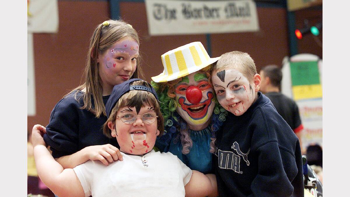Ashlea Smith, 11, of Wangaratta, Maddison Besant, 11, of Wodonga, Sparky the Clown and Tim Smith, 9, of Wangaratta, enjoy the Special Childrens' Christmas Party at the Wodonga Sports and Leisure Centre. Picture: PETER MERKESTEYN