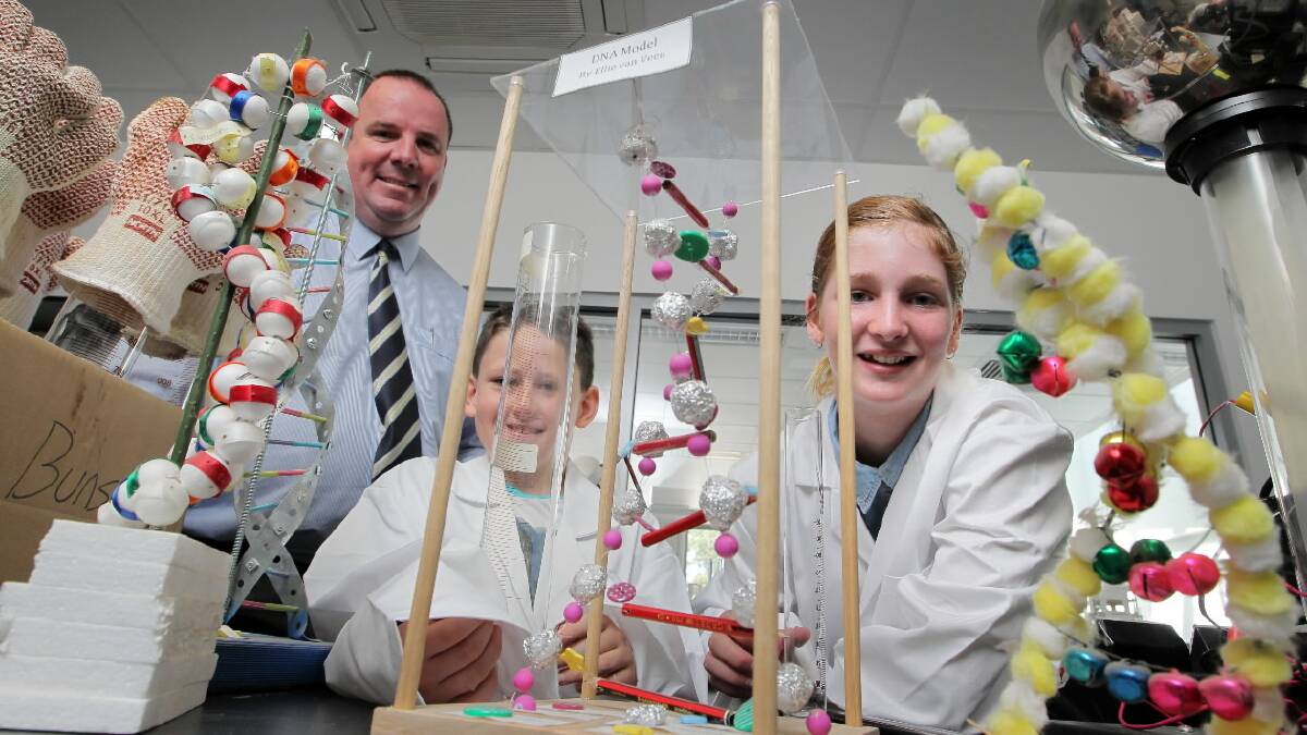 Trinity Anglican principal Steven O’Connor with students Connor Willis, 9, and Sidney White, 11, try out some equipment in the school’s new science building. Picture: DAVID THORPE
