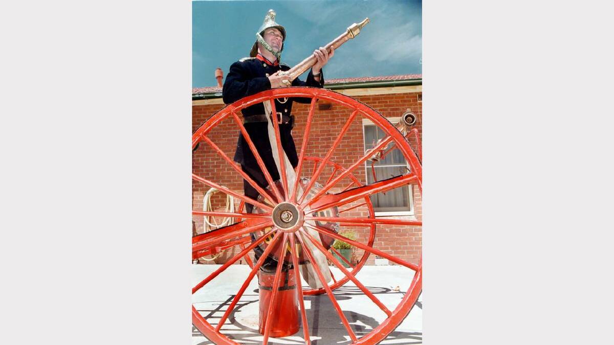 Open day at the Albury Fire Station. Stephen Norman, firefighter for the 209 Albury Civic fire station in Kiewa Street, poses with a hose reel used from the 1870s to 1940s. Picture: CHRIS McCORMACK