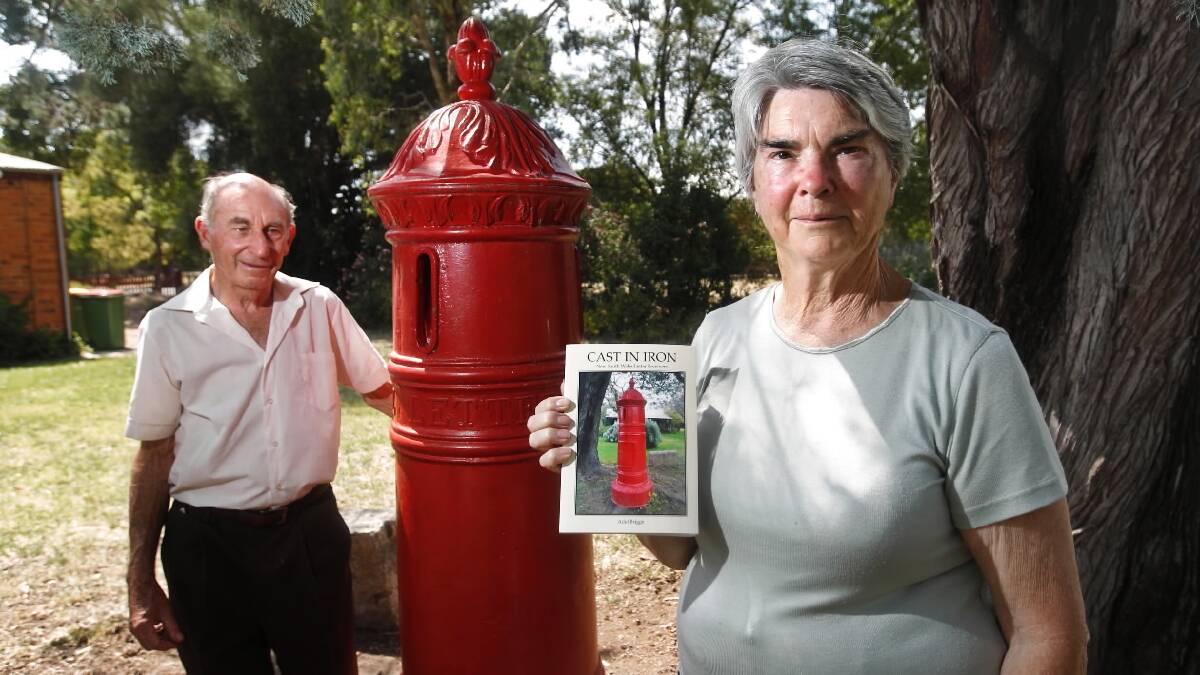 Graham and Adel Briggs, holding her book, in front of a 19th century letter receiver they donated to the Jindera Pioneer Museum. Picture: BEN EYLES