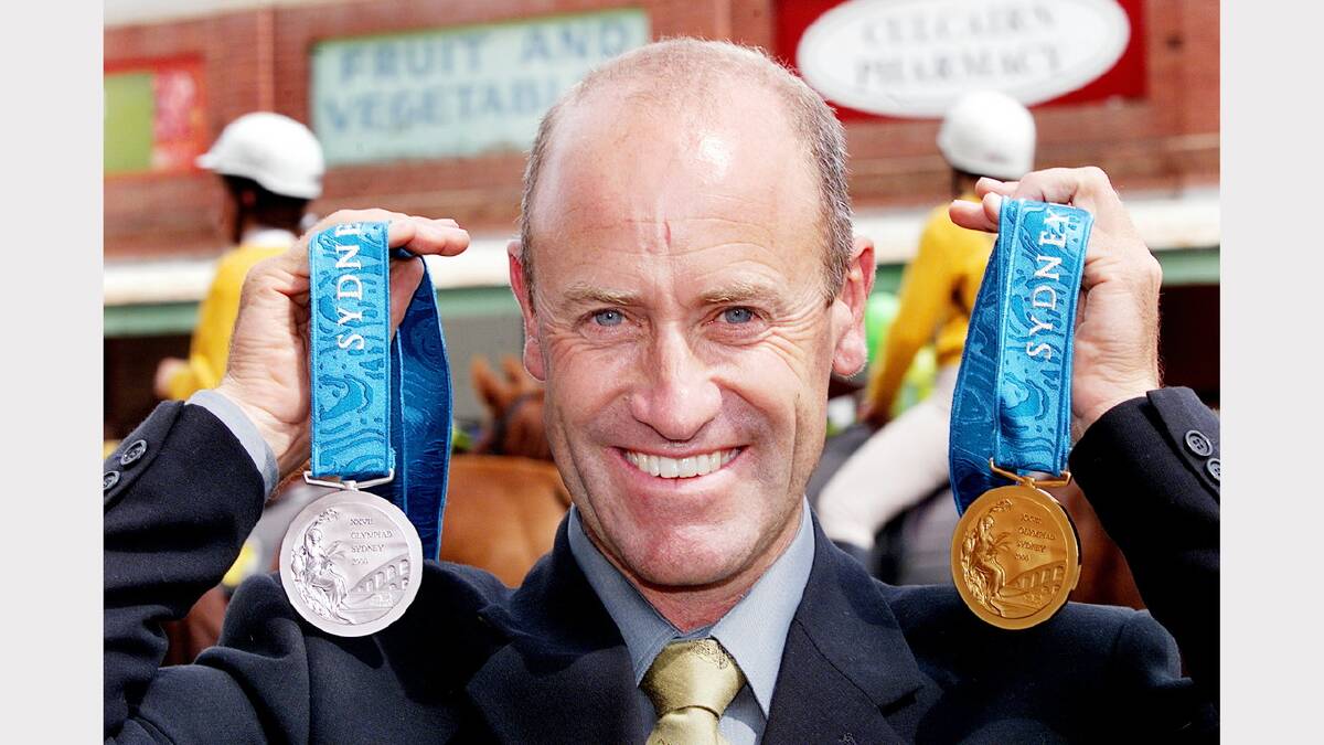 Andrew Hoy proudly displays his olympic medals in his home town of Culcairn following the 2000 Olympic Games in Sydney.