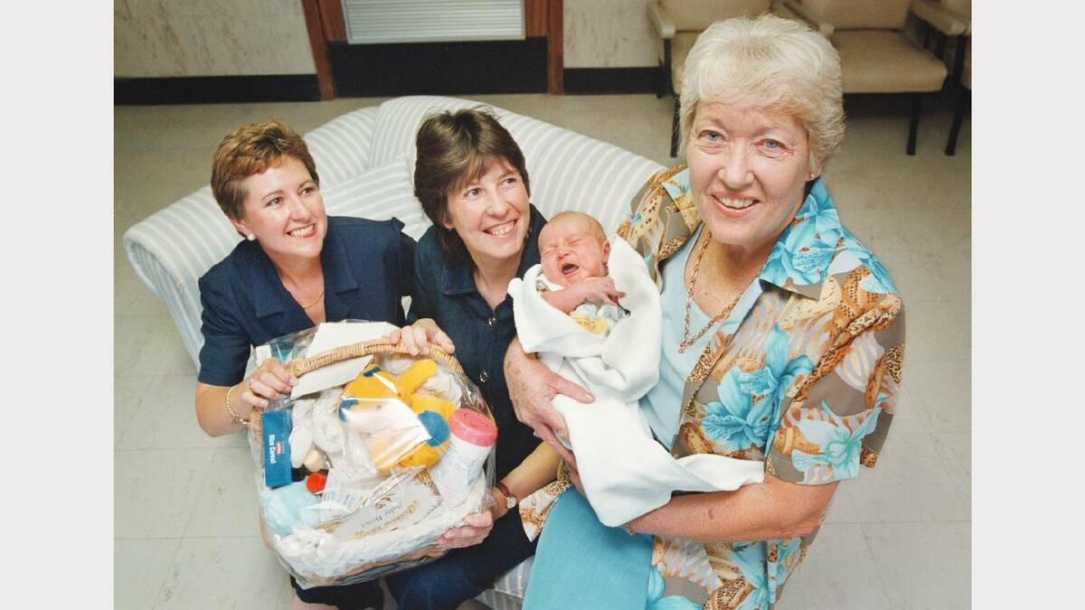 The Inner Wheel Club of Wodonga presented a baby basket to Mrs Diana Smith of Albury (centre), and her baby, Hudson Royce, this morning, to help celebrate the club's third birthday (Hudson was born on the actual birthday, November 18). On the left is the club's vice president, Mrs Beth McRae and on the right is Mrs Lillian Matton, club president, with Hudson. Picture: PETER BATSON