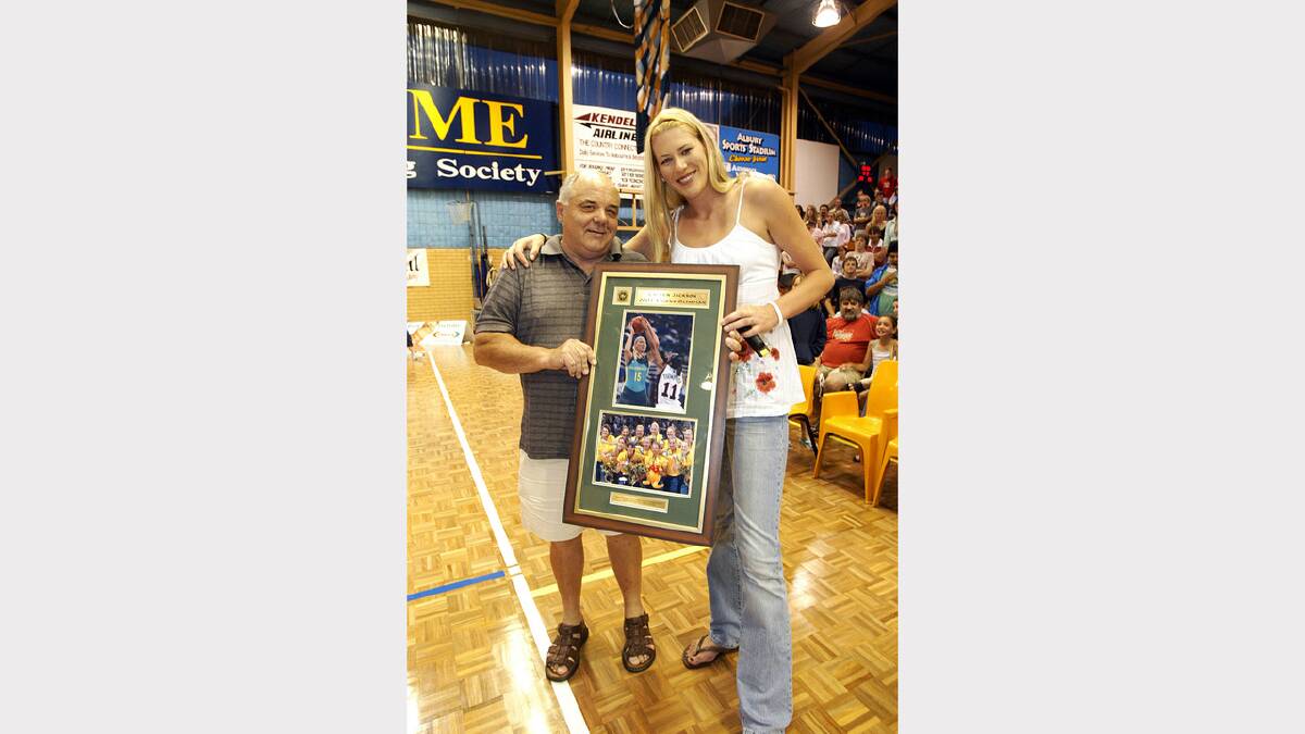 Border basketball identity Carl Iverson was presented with this framed photo by Lauren Jackson during half-time of the WNBL game between Canberra and the AIS at the Albury Sports Stadium. Picture: PETER MERKESTEYN
