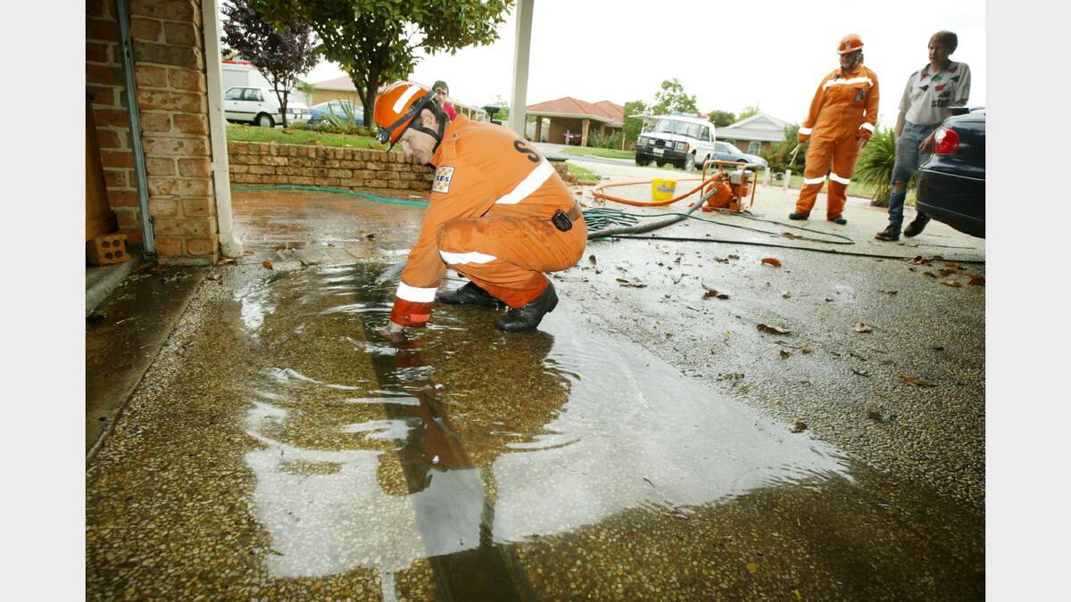 Wodonga was hit by a storm that caused flash flooding. Wade Baard from the Wodonga SES helps to pump out the water from a house in Delatite Crt. Picture: SIMON DALLINGER