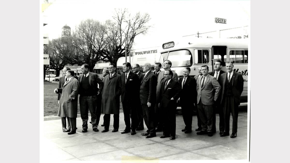 Albury City Council 1968 Winter Inspection. Pictured is Les Carret, Tom Pearsall, Ned Griffith, Barry Dangerfield, Ralph Marks, Vic Prendergast, Max Barry, Cleaver Bunton, Max Luff, John Roach, Eddie Batrouney, Town Clerk Jack Carter, Fred Brumm, Paul Wallace, Bob Messervey and Karl Weiss standing in front of Martin's bus, with CML clock, Woolworths and Coles in background. Picture: ALBURYCITY COLLECTION