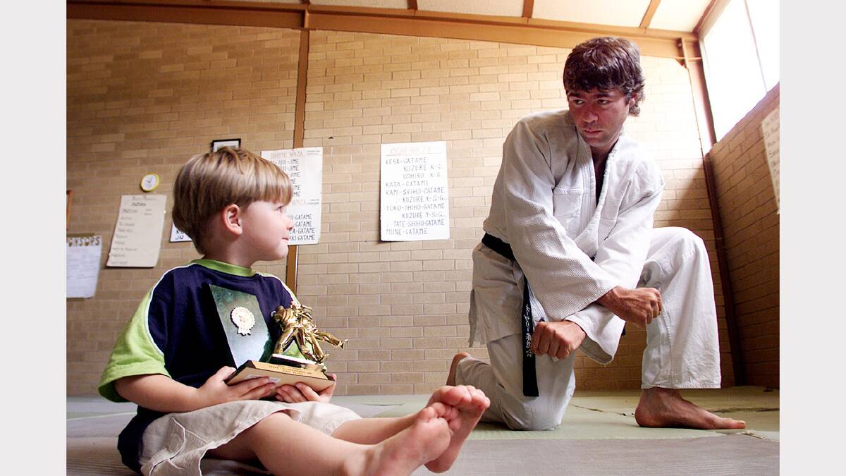 Tim McEvoy (right) came first in the Judo Victoria State Championships for 2001. He is trying to encourage youngsters such as his nephew James McEvoy (left), 3, of Lavington, to take up the sport. Picture: MATTHEW SMITHWICK