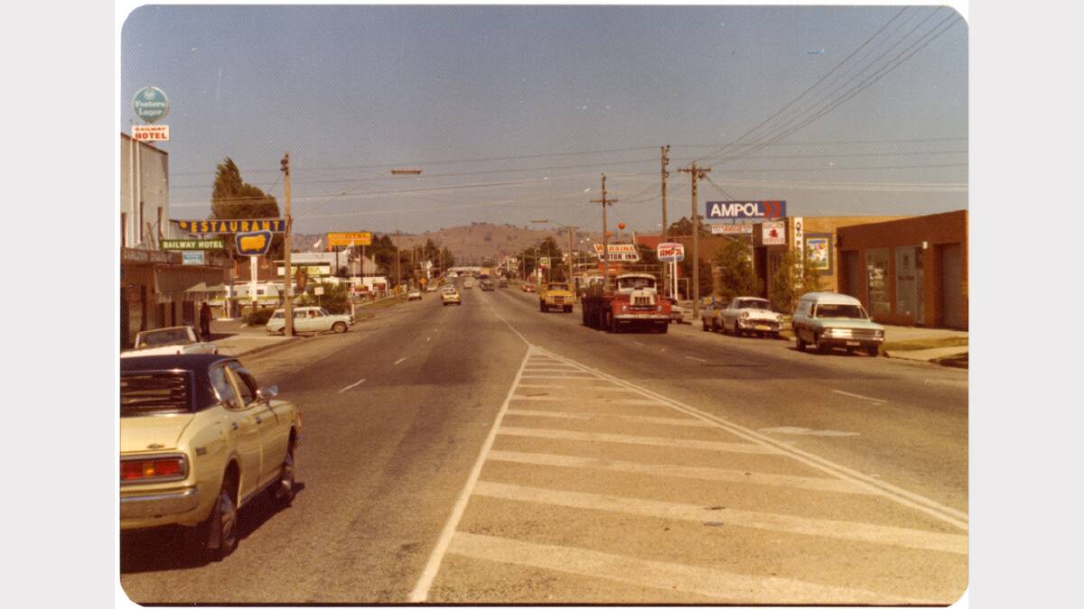 High Street, Wodonga, looking south on March 30, 1976. Ampol Service Station on western side of street, Golden Fleece sign just visible on east side of street. BP sign visible on western side much further down street. Signs for motels are also visible on each side of street. Picture: ALBURYCITY COLLECTION